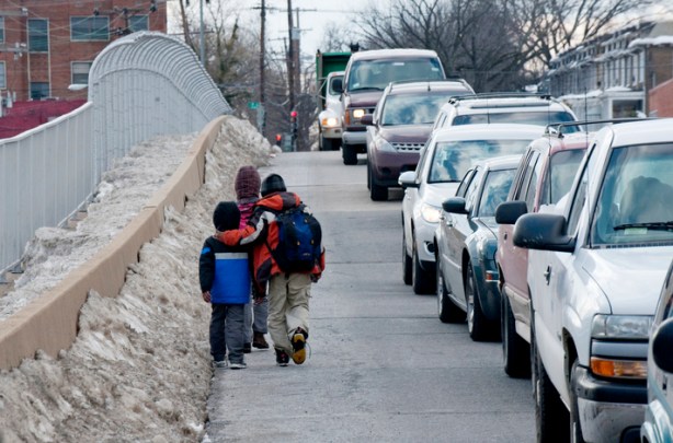 Children dangerously walk along a foot bridge in Northeast to go to and from school.